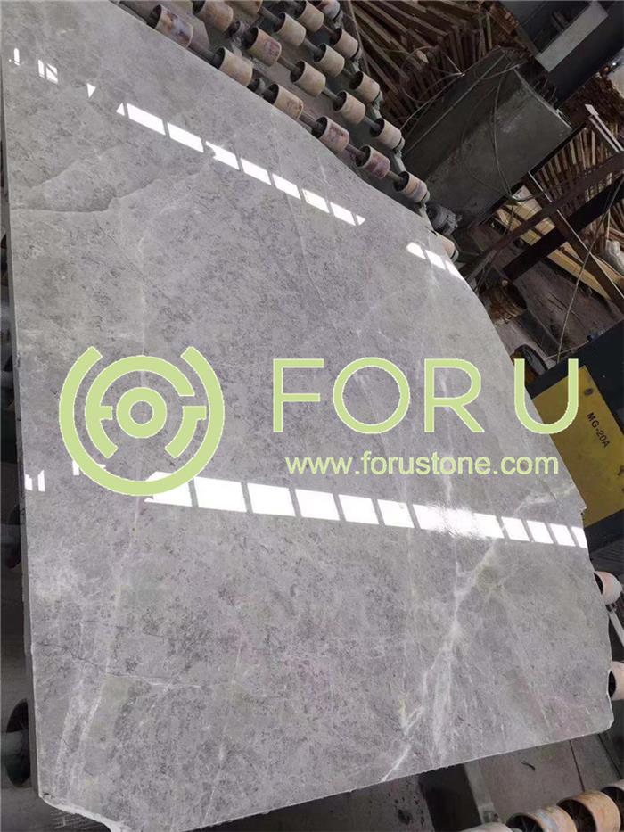 Large inventory of Castle Grey (Tundra Grey) marble slabs in a high-capacity stone warehouse, ready for commercial project orders.