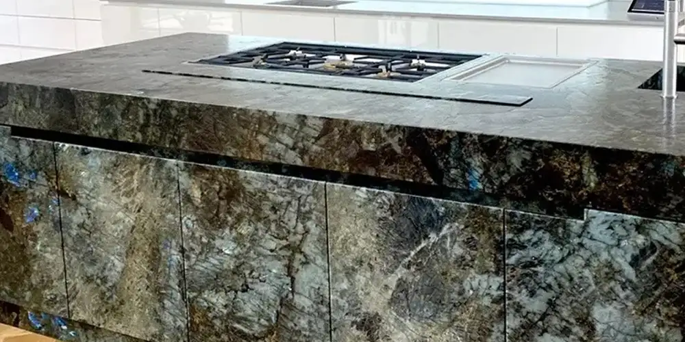 Lemurian Blue Granite 2026: Technical Guide for Luxury Hotel Bars & Cut-to-Size Tiles 2 Engineering-Opulence-Why-Blue-Labradorite-Granite-is-the-Premier-Choice-for-2026-High-Traffic-Commercial-Interiors