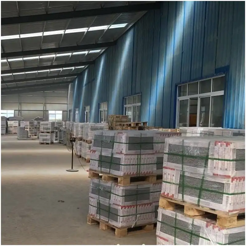 Granite Stone Factory Warehouse Mass Wrapped Finished Granite Products Bulk Export Stock Spacious Stone Factory Warehouse Full of Wrapped Granite Tiles Slabs on Wooden Pallets Large Volume Finished Granite Stone Stock Ready for Shipment