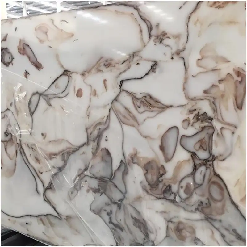 Artificial Onyx Marble slab with white background and soft grey brown flowing patterns